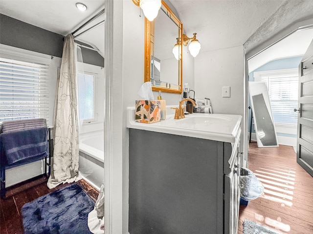 634 6th St N, Saint Petersburg, FL 33701 - full bathroom featuring vanity, wood finished floors, and shower / tub combo