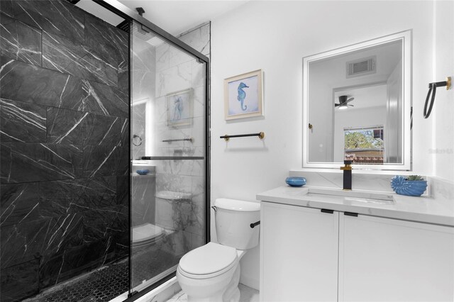 1851 Oklahoma Ave NE, Saint Petersburg, FL 33703 - bathroom with vanity, toilet, and a marble finish shower