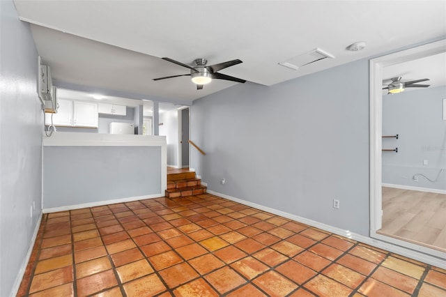 1115 Highland St N, Saint Petersburg, FL 33701 - unfurnished living room featuring ceiling fan and baseboards