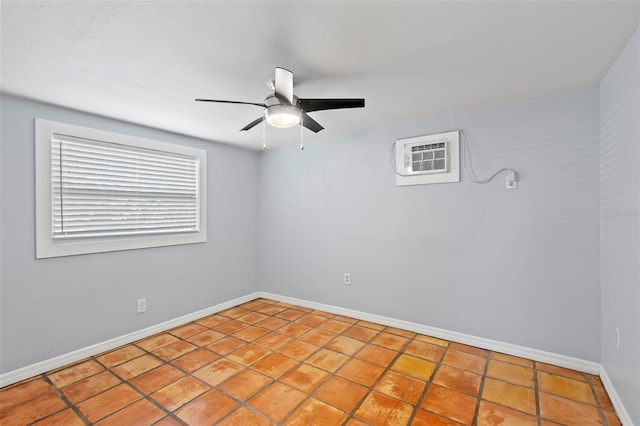 1115 Highland St N, Saint Petersburg, FL 33701 - empty room featuring ceiling fan, baseboards, tile patterned floors, and a wall mounted air conditioner