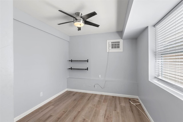 1115 Highland St N, Saint Petersburg, FL 33701 - unfurnished room featuring wood finished floors, ceiling fan, baseboards, and a wall mounted AC