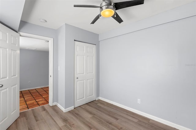 1115 Highland St N, Saint Petersburg, FL 33701 - unfurnished bedroom featuring wood finished floors, baseboards, a closet, and ceiling fan