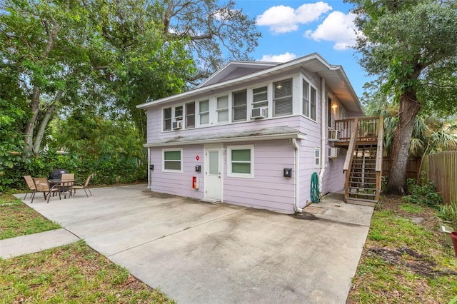 1115 Highland St N, Saint Petersburg, FL 33701 - view of front facade featuring stairs, a patio, a deck, and cooling unit
