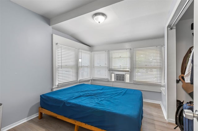 1115 Highland St N, Saint Petersburg, FL 33701 - bedroom with vaulted ceiling, wood finished floors, baseboards, and cooling unit