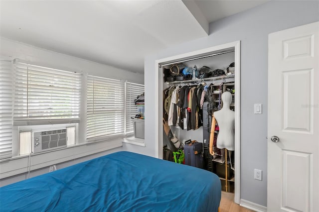 1115 Highland St N, Saint Petersburg, FL 33701 - bedroom featuring a closet, wood finished floors, cooling unit, and baseboards