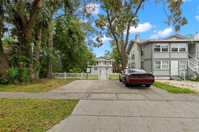 1115 Highland St N, Saint Petersburg, FL 33701 - view of side of property with a chimney and driveway