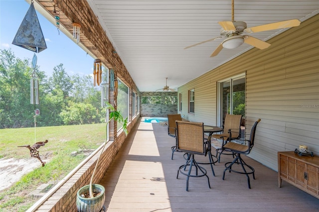 14365 Evans Ranch Rd, Lakeland, FL 33809 - wooden deck featuring ceiling fan, outdoor dining space, and a lawn