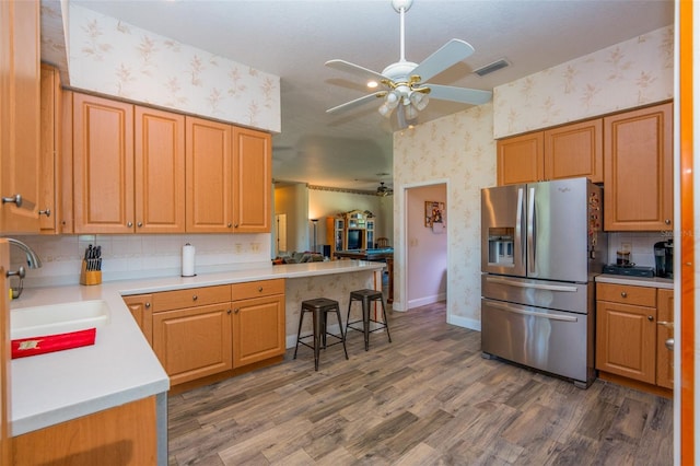 14365 Evans Ranch Rd, Lakeland, FL 33809 - kitchen featuring stainless steel refrigerator with ice dispenser, wallpapered walls, a sink, a ceiling fan, and wood finished floors