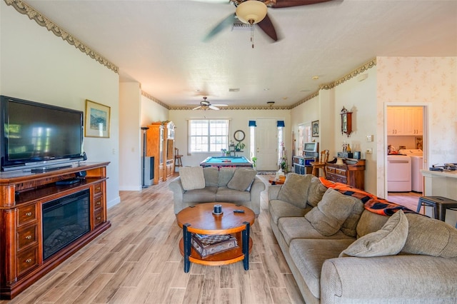 14365 Evans Ranch Rd, Lakeland, FL 33809 - living area featuring ceiling fan, independent washer and dryer, light wood-style floors, and baseboards