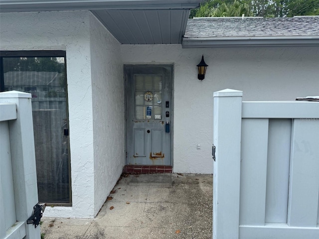 1371 Pine Ridge Cir E Unit B8, Tarpon Springs, FL 34688 - doorway to property with stucco siding