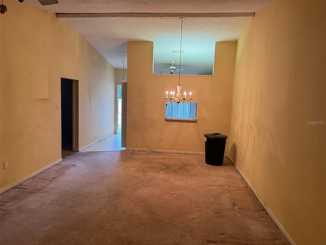 1371 Pine Ridge Cir E Unit B8, Tarpon Springs, FL 34688 - unfurnished dining area featuring a chandelier, carpet, baseboards, and a textured ceiling