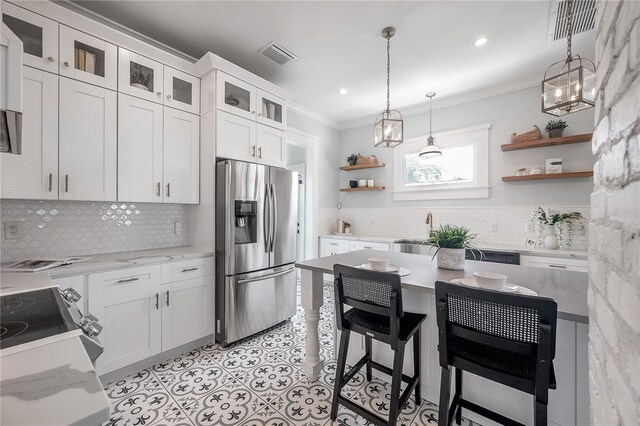 5301 N Central Ave, Tampa, FL 33603 - kitchen with stainless steel refrigerator with ice dispenser, open shelves, crown molding, backsplash, and white cabinetry