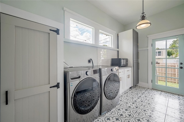 5301 N Central Ave, Tampa, FL 33603 - laundry area featuring cabinet space, independent washer and dryer, healthy amount of natural light, and light tile patterned floors