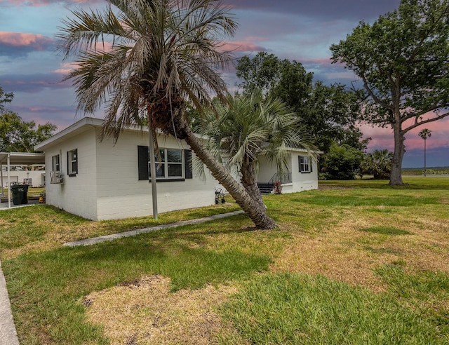 1816 W Lake Parker Dr, Lakeland, FL 33805 - property exterior at dusk with a yard and concrete block siding