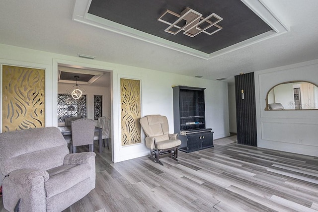 1816 W Lake Parker Dr, Lakeland, FL 33805 - living area featuring wood finished floors, a raised ceiling, and baseboards