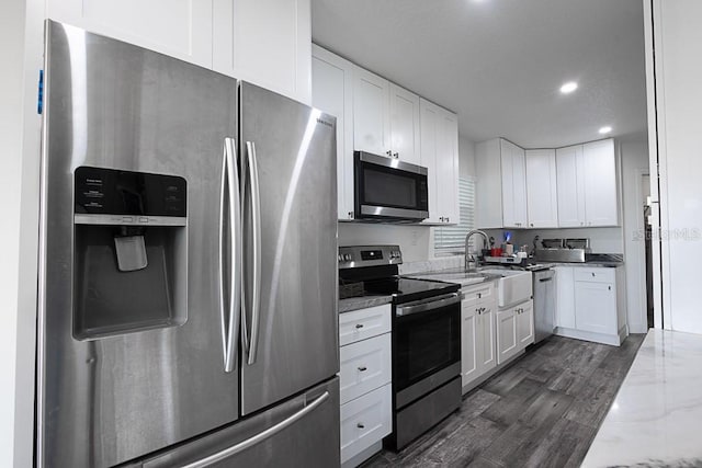 1816 W Lake Parker Dr, Lakeland, FL 33805 - kitchen featuring appliances with stainless steel finishes, a sink, white cabinets, light stone countertops, and recessed lighting