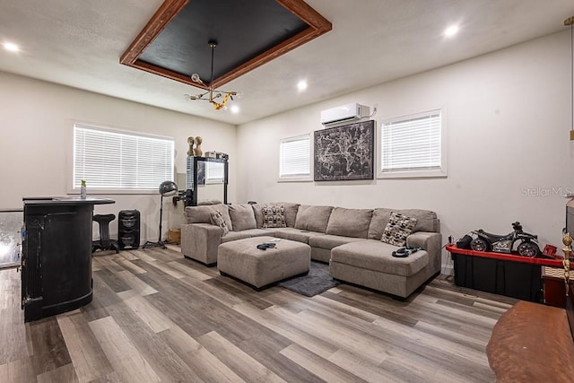 1816 W Lake Parker Dr, Lakeland, FL 33805 - living area with wood finished floors, a wall unit AC, recessed lighting, and a tray ceiling