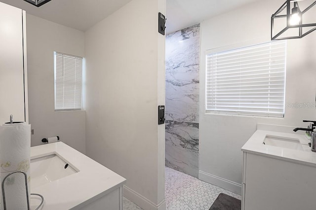 1816 W Lake Parker Dr, Lakeland, FL 33805 - bathroom with double vanity, a marble finish shower, and baseboards