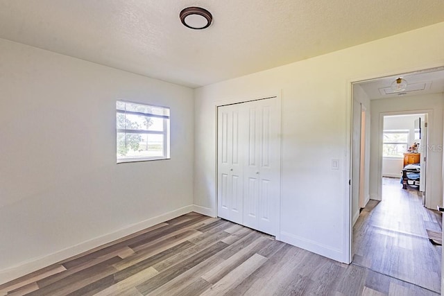 1816 W Lake Parker Dr, Lakeland, FL 33805 - unfurnished bedroom featuring wood finished floors, baseboards, and a closet