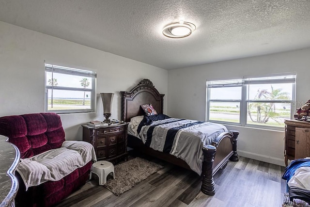 1816 W Lake Parker Dr, Lakeland, FL 33805 - bedroom with wood finished floors, a textured ceiling, and baseboards