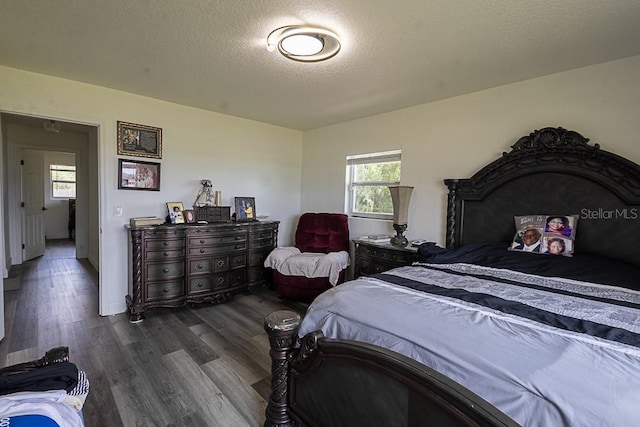 1816 W Lake Parker Dr, Lakeland, FL 33805 - bedroom with dark wood-style flooring and a textured ceiling