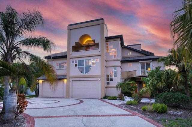 812 Point Seaside Dr, Crystal Beach, FL 34681 - view of front of house with an attached garage, stucco siding, and curved driveway