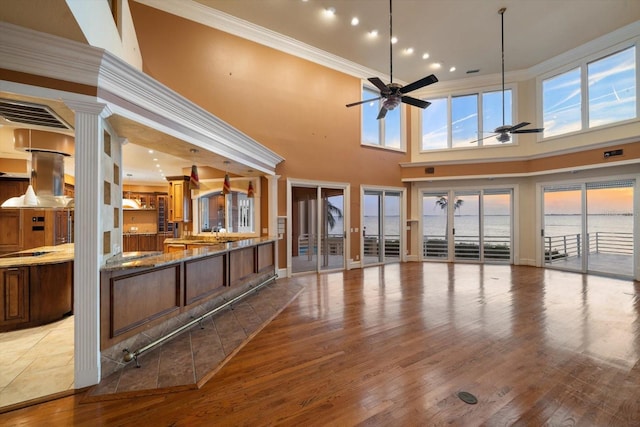 812 Point Seaside Dr, Crystal Beach, FL 34681 - unfurnished living room featuring a ceiling fan, ornamental molding, french doors, wood finished floors, and recessed lighting