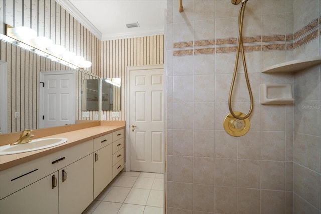 812 Point Seaside Dr, Crystal Beach, FL 34681 - bathroom featuring ornamental molding, tiled shower, vanity, wallpapered walls, and tile patterned floors