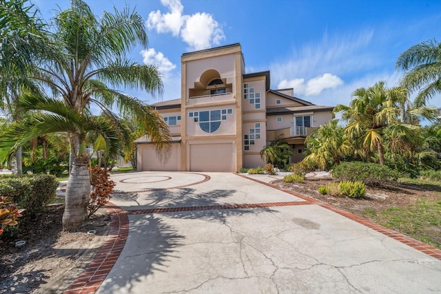 812 Point Seaside Dr, Crystal Beach, FL 34681 - view of front of house with an attached garage, curved driveway, and stucco siding