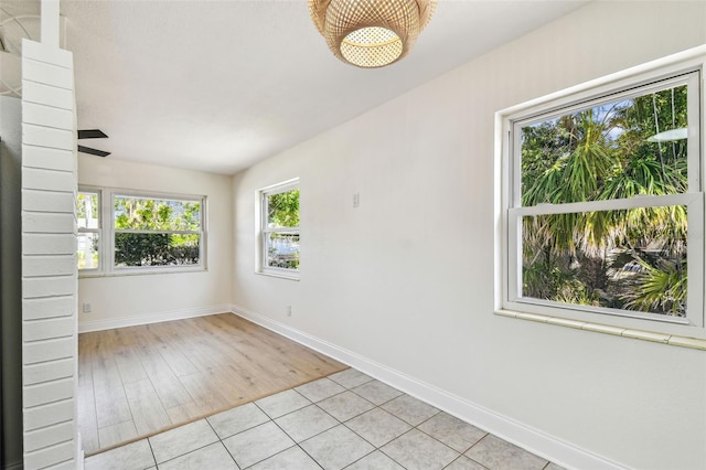 3818 Grove St S, Saint Petersburg, FL 33705 - spare room featuring baseboards and light tile patterned floors