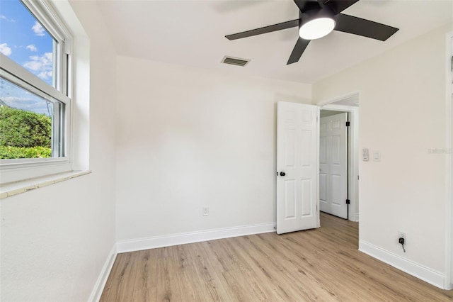 3818 Grove St S, Saint Petersburg, FL 33705 - unfurnished room with light wood-style floors, ceiling fan, and baseboards