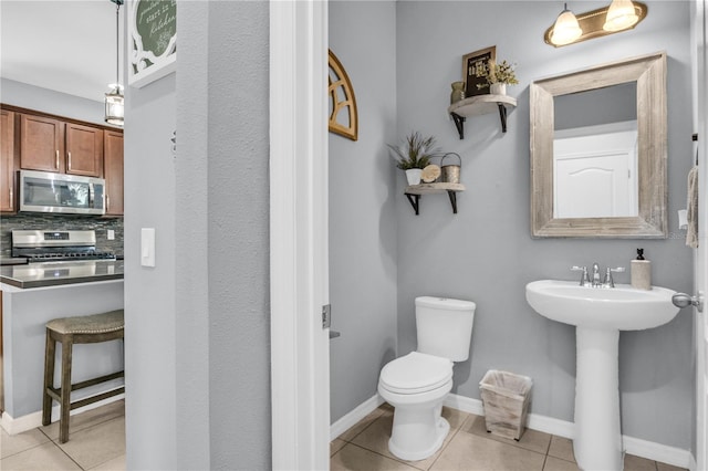 7238 Milestone Dr, Apollo Beach, FL 33572 - half bath with toilet, tile patterned flooring, and a sink