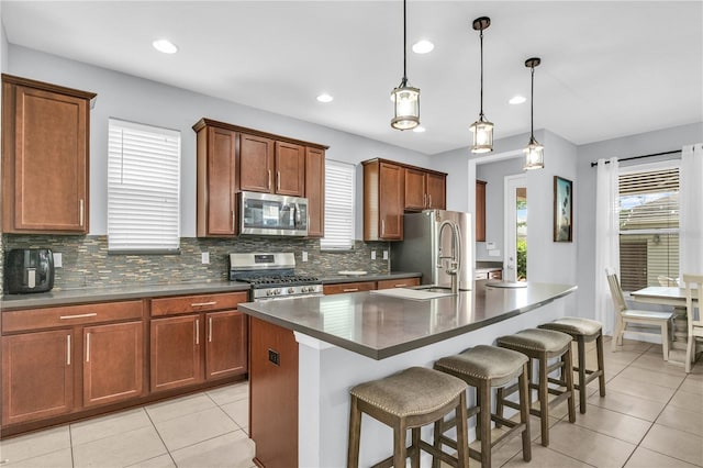 7238 Milestone Dr, Apollo Beach, FL 33572 - kitchen with appliances with stainless steel finishes, a sink, light tile patterned flooring, dark countertops, and recessed lighting