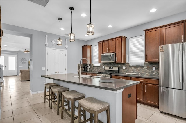 7238 Milestone Dr, Apollo Beach, FL 33572 - kitchen featuring appliances with stainless steel finishes, a sink, dark countertops, light tile patterned floors, and tasteful backsplash