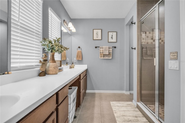 7238 Milestone Dr, Apollo Beach, FL 33572 - bathroom featuring double vanity, a shower stall, tile patterned floors, and baseboards