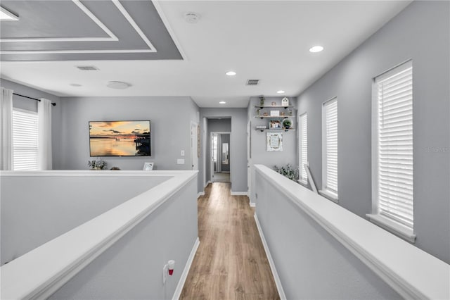 7238 Milestone Dr, Apollo Beach, FL 33572 - corridor with light wood-style floors, healthy amount of natural light, baseboards, an upstairs landing, and recessed lighting