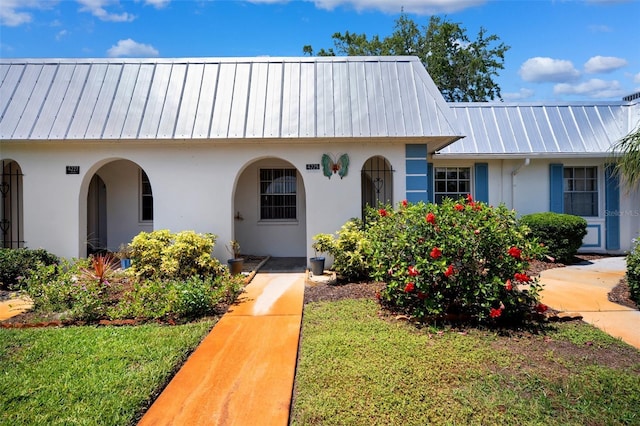 4229 Glissade Dr, New Port Richey, FL 34652 - view of front of property featuring stucco siding and metal roof
