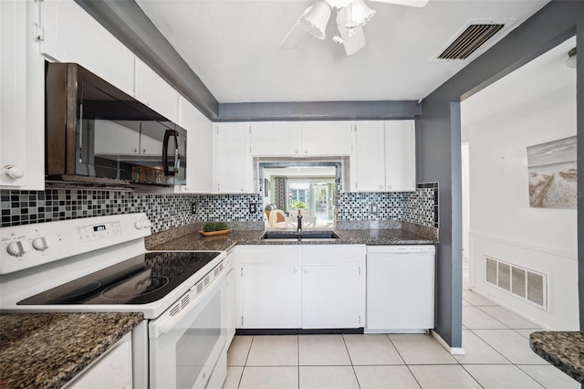 4229 Glissade Dr, New Port Richey, FL 34652 - kitchen featuring white appliances, a sink, light tile patterned floors, decorative backsplash, and white cabinets