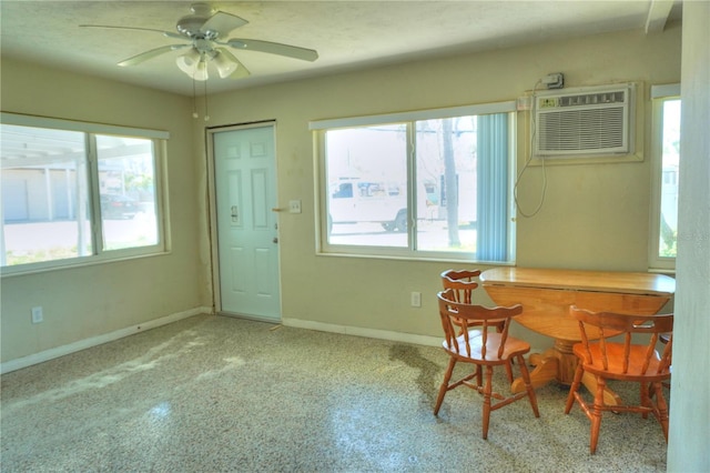 14501 N Bayshore Dr, Madeira Beach, FL 33708 - dining room with healthy amount of natural light, ceiling fan, a wall mounted air conditioner, and baseboards