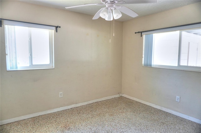 14501 N Bayshore Dr, Madeira Beach, FL 33708 - spare room featuring baseboards and a ceiling fan