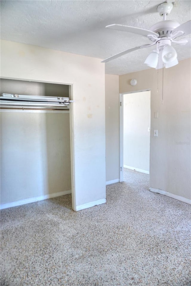14501 N Bayshore Dr, Madeira Beach, FL 33708 - unfurnished bedroom with baseboards, a closet, a textured ceiling, and ceiling fan