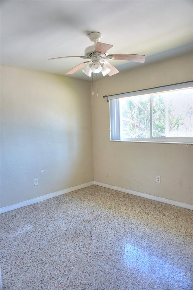 14501 N Bayshore Dr, Madeira Beach, FL 33708 - spare room with a ceiling fan and baseboards