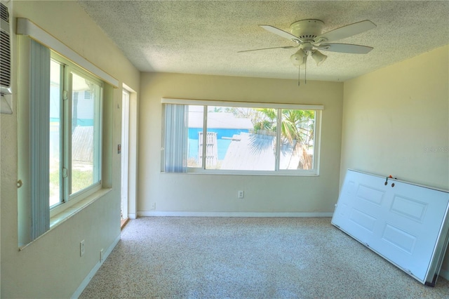 14501 N Bayshore Dr, Madeira Beach, FL 33708 - carpeted spare room with ceiling fan, a textured ceiling, and baseboards