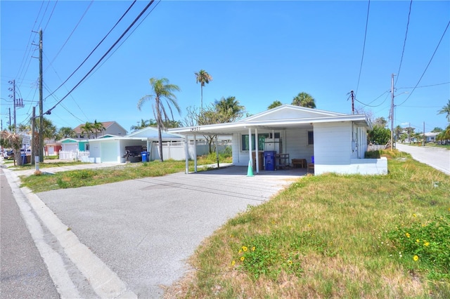 14501 N Bayshore Dr, Madeira Beach, FL 33708 - view of front facade featuring an attached carport and asphalt driveway