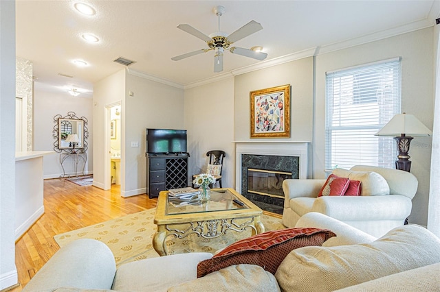 350 2nd St N Unit 1, Saint Petersburg, FL 33701 - living room with light wood finished floors, crown molding, ceiling fan, a premium fireplace, and baseboards