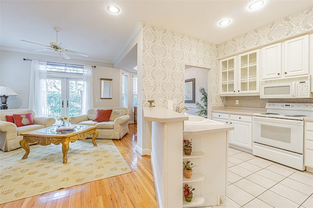 350 2nd St N Unit 1, Saint Petersburg, FL 33701 - kitchen featuring white appliances, crown molding, open floor plan, open shelves, and wallpapered walls