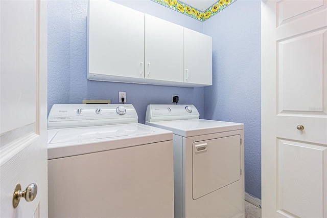 350 2nd St N Unit 1, Saint Petersburg, FL 33701 - laundry room featuring cabinet space, washing machine and clothes dryer, and a textured wall