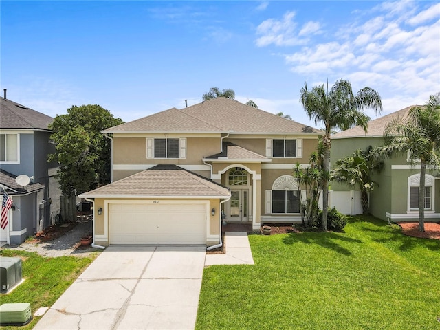 4852 Trinidad Dr, Land O Lakes, FL 34639 - view of front of house featuring stucco siding, driveway, a garage, a front yard, and a shingled roof