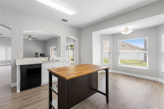 4852 Trinidad Dr, Land O Lakes, FL 34639 - kitchen featuring dishwasher, a sink, white cabinetry, and light wood-type flooring