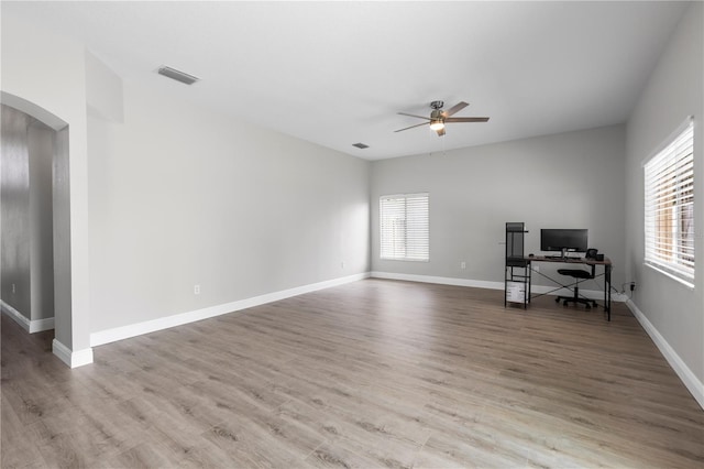 4852 Trinidad Dr, Land O Lakes, FL 34639 - unfurnished office featuring arched walkways, a ceiling fan, wood finished floors, and baseboards
